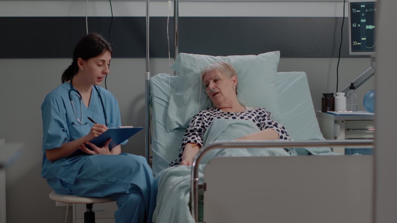 Nurse and elder patient talking about healthcare and treatment