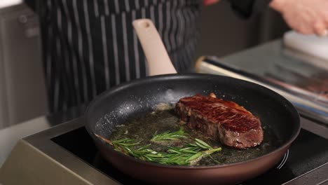 chef cooking steak with rosemary