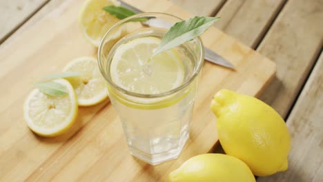 Video-of-glass-with-lemonade-and-lemons-on-wooden-board