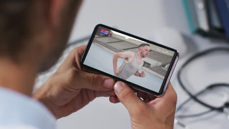 composite of male doctor watching athletics event on smartphone