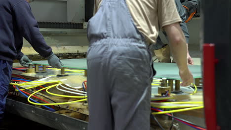 installing a huge matted glass panel on cnc machine table, holding it in place with air sucker pistons