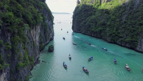 Long-Tail-Boat-Leaving-Tropical-Island,-Pileh-Lagoon