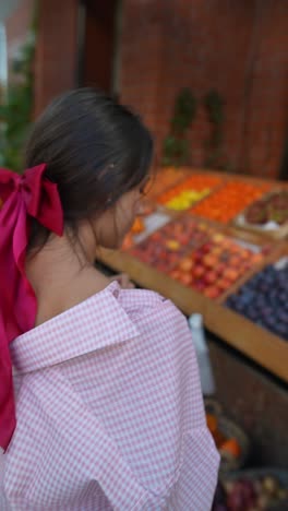 woman shopping for fruit at a farmer's market