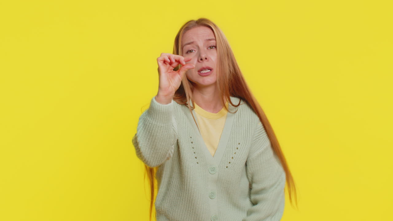 Woman show a little bit gesture begging help need some more please give me measuring small size