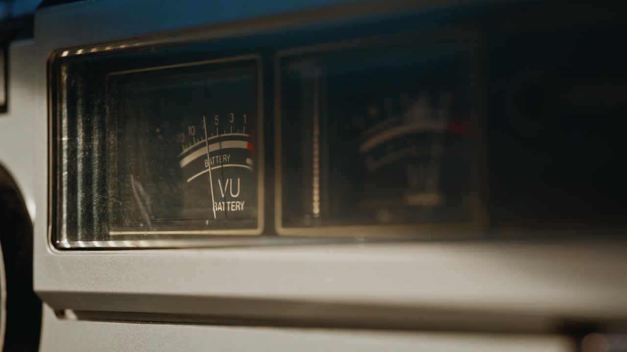 UV needle moving inside audio scale on vintage tuner closeup. Macro volume meter