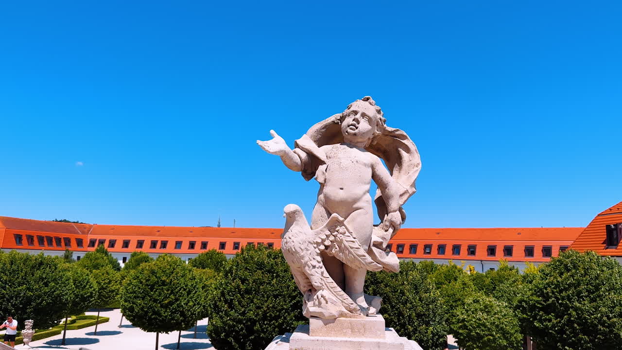 Statue decorating the courtyard of the Bratislava Castle in Slovakia. Green garden at backdrop