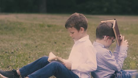 boys in school uniform prepare for exam sitting on grass