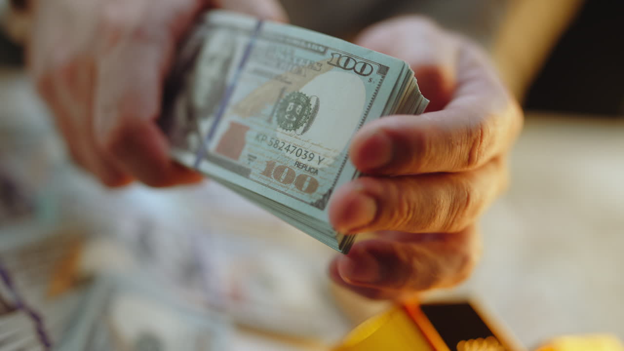 Stack of Hundred Dollar Bills in Hands