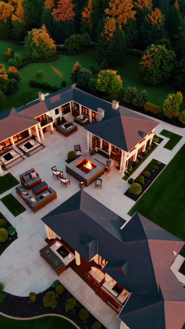 Aerial View of a Luxury Estate with Fire Pit and Outdoor Living Space at Dusk