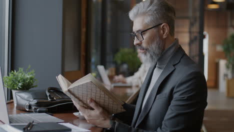 businessman reading in a cafe