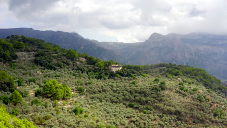 AERIAL:-Jungle-Mountains-on-Tropical-Island-Mallorca,-Spain-on-Sunny-Day-Vacation,-Travel,-Sunny,-Waves