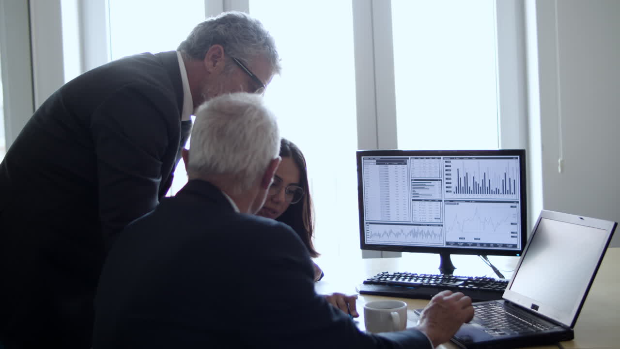 Group of investors or brokers discussing stock market charts