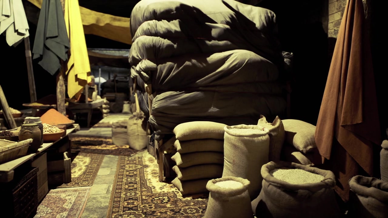 Historical trading area featuring woven fabrics and pottery displays
