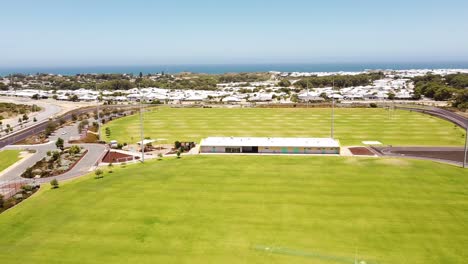 Yanchep-Splendid-Park-sports-facilities-and-perimeter-cycle-track,-aerial-view-with-ocean