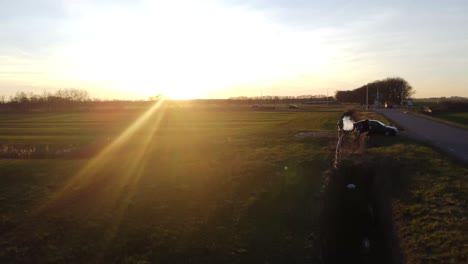 beautiful sunset drone shot with farm fields, trees and traffic