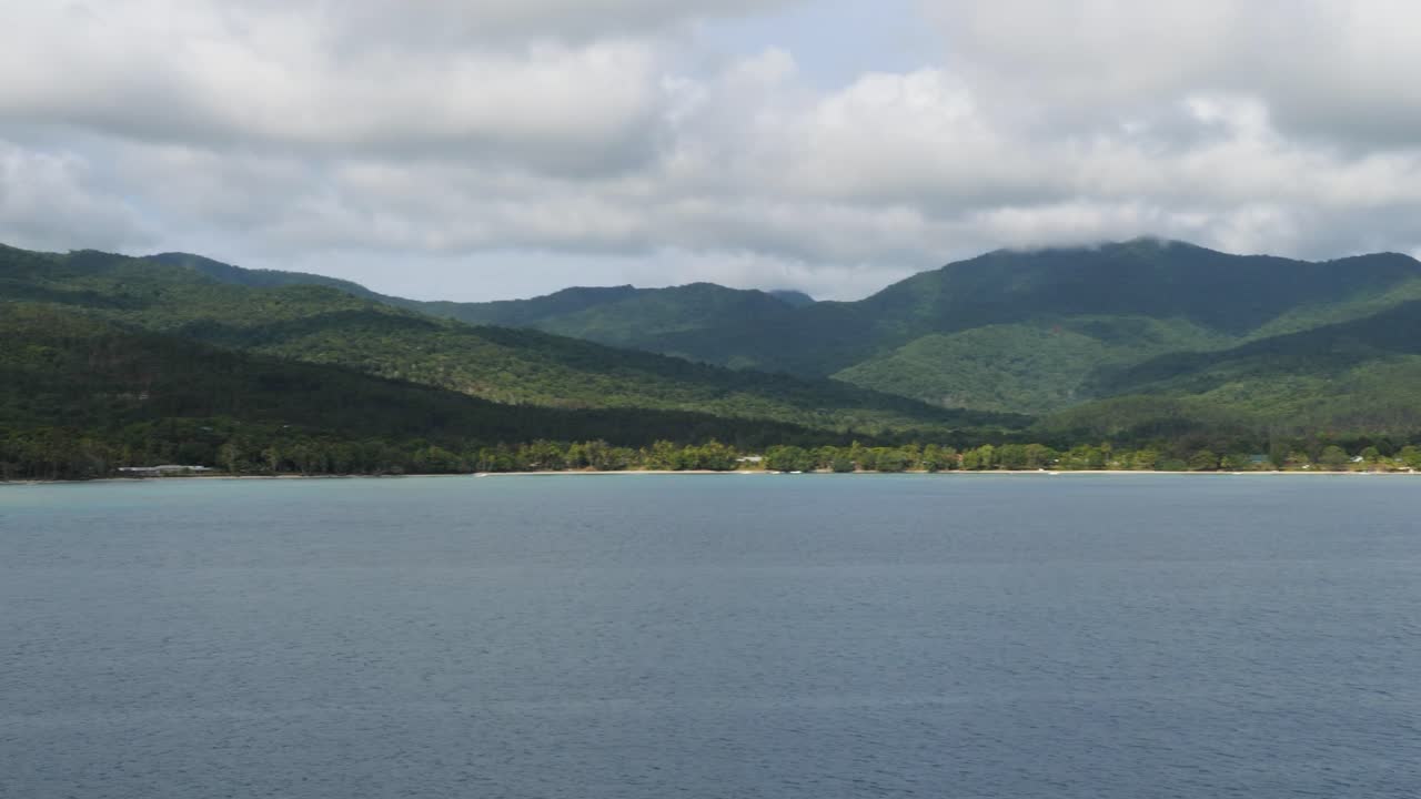 Tropical Island Paradise: Lush Green Mountains and Calm Blue Ocean