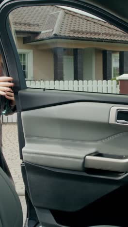 woman in a car looking at her phone