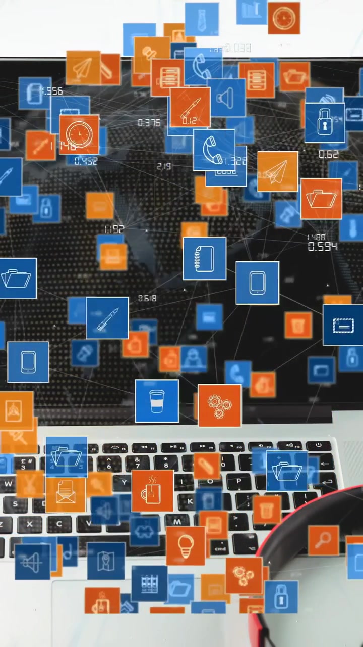 Vertical video: Laptop getting data on desk, blue icons forming network over keys showing IT stats