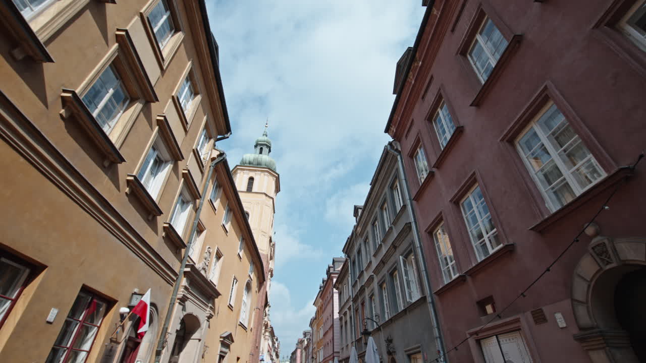 View of Warsaw's Old Town, Stare Miasto, with colorful buildings and a historic church tower