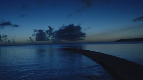 Una-Tranquila-Vista-Nocturna-Con-Un-Muelle-Flotante-Sobre-Aguas-Tranquilas