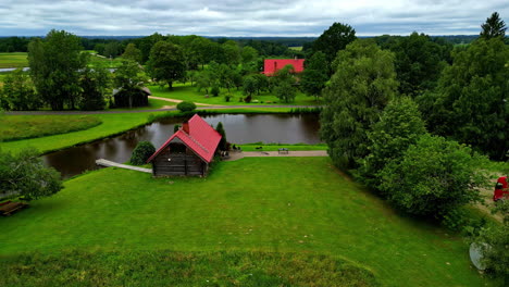 Holiday-home-in-idyllic-nature-landscape-at-lake,-aerial-beautiful-rural