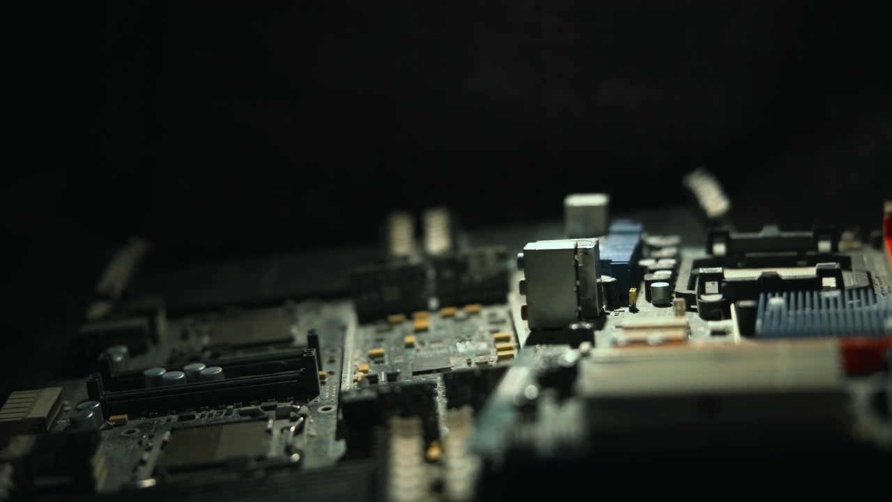 Cinematic Closeup Of Motherboard Components, Lowkey Studio Lighting Creates Silhouettes And Deep Shadows,