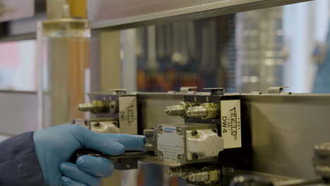 professor's hand showing how the different levers works in a hydraulics lab