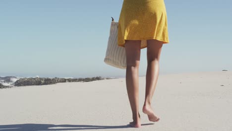 african american woman walking seaside