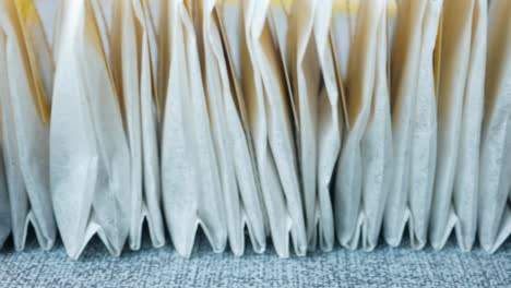 Tea-bags-and-yellow--mug-on-table