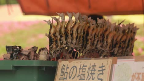 shioyaki - grilled fish on a stick often found in street food market stores as a japanese snack