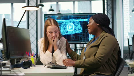 employee helping upset friend in need at work, comforting coworker