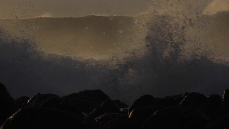 huge waves roll in and crash against a rocky shoreline 5