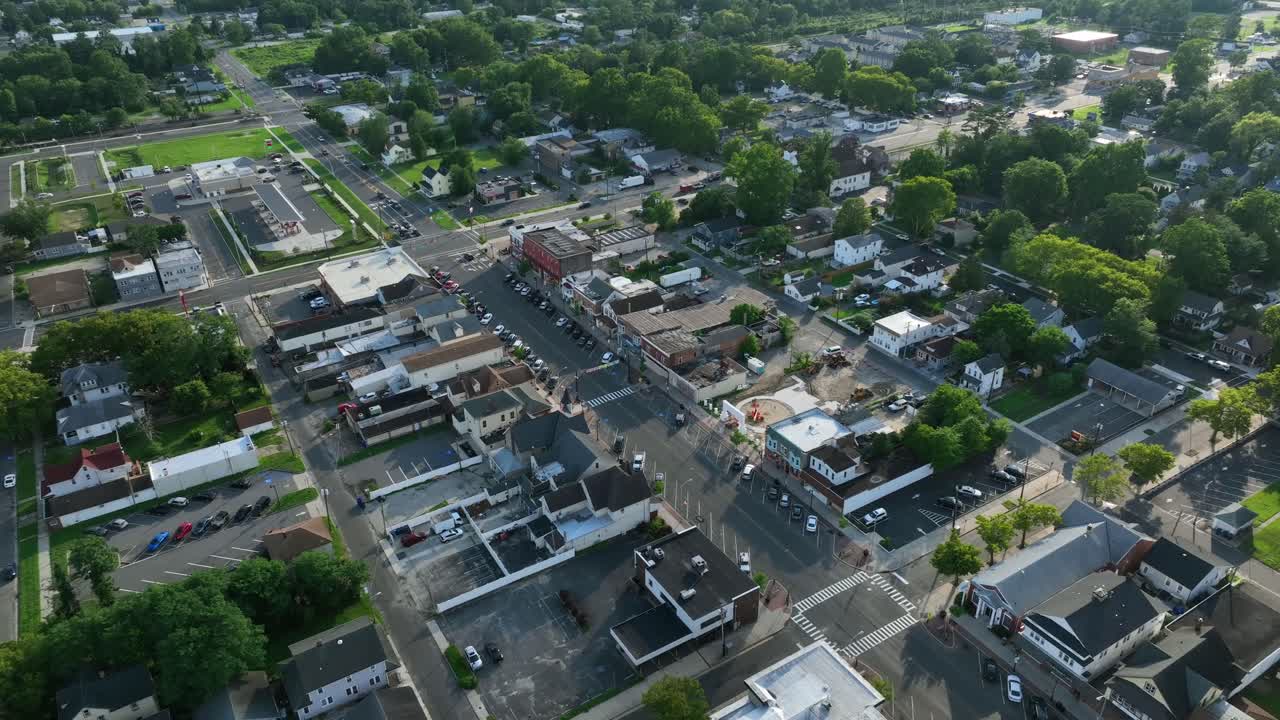 Parking cars on square of American town in egg harbor city, New Jersey. drone top down. Historic buildings and homes along road and junction. Summer day in USA