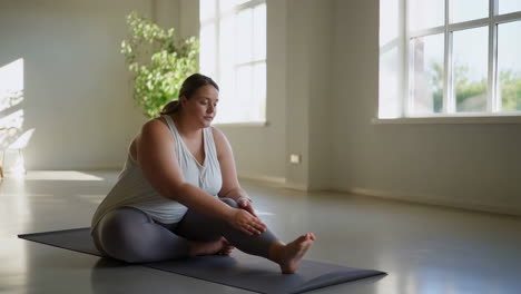 plus-size woman stretching in yoga pose