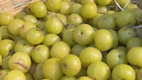 Indian gooseberry also called (amla) in bamboo basket for sale, it is used to make gooseberry pickle