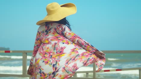 a young woman turns in her beach throw over revealing a bikini bottom