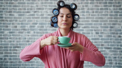 woman enjoying morning drink in bathrobe