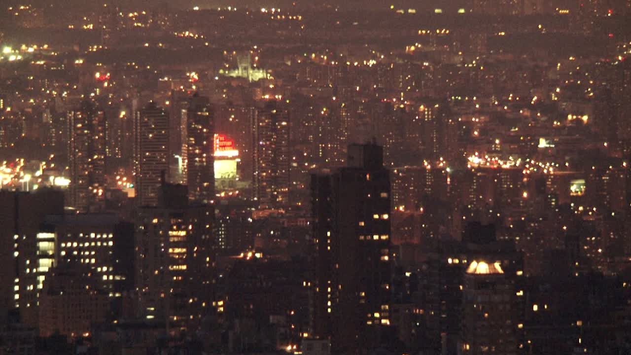 City lights at night, aerial view of illuminated skyscrapers in New York