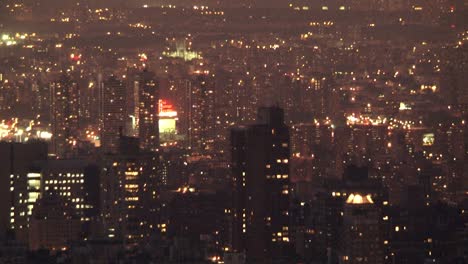 city lights at night, aerial view of illuminated skyscrapers in new york