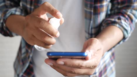 cleaning a smartphone with hand sanitizer