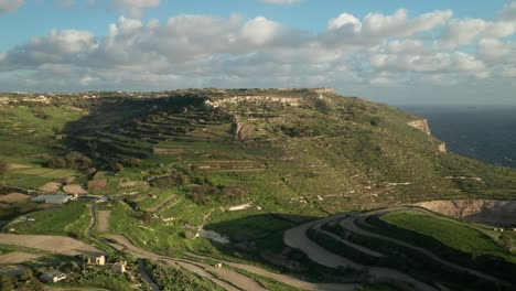 AERIAL:-Sun-Setting-on-Hills-with-Paddy-Fields-on-a-Warm-Winter-Evening-in-Malta