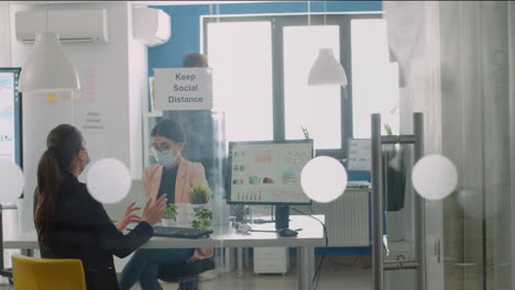 businesswoman wearing protective face mask working on computer