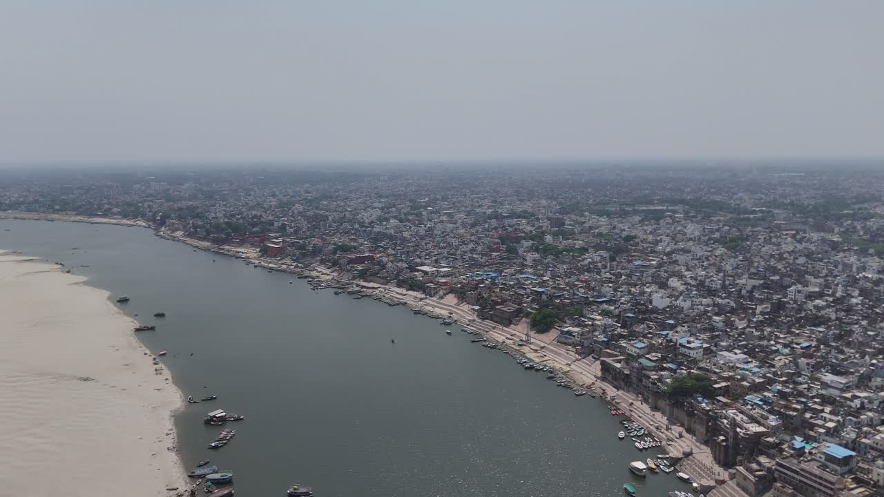Sunny over the Ganges River with boats floating in Varanasi, India