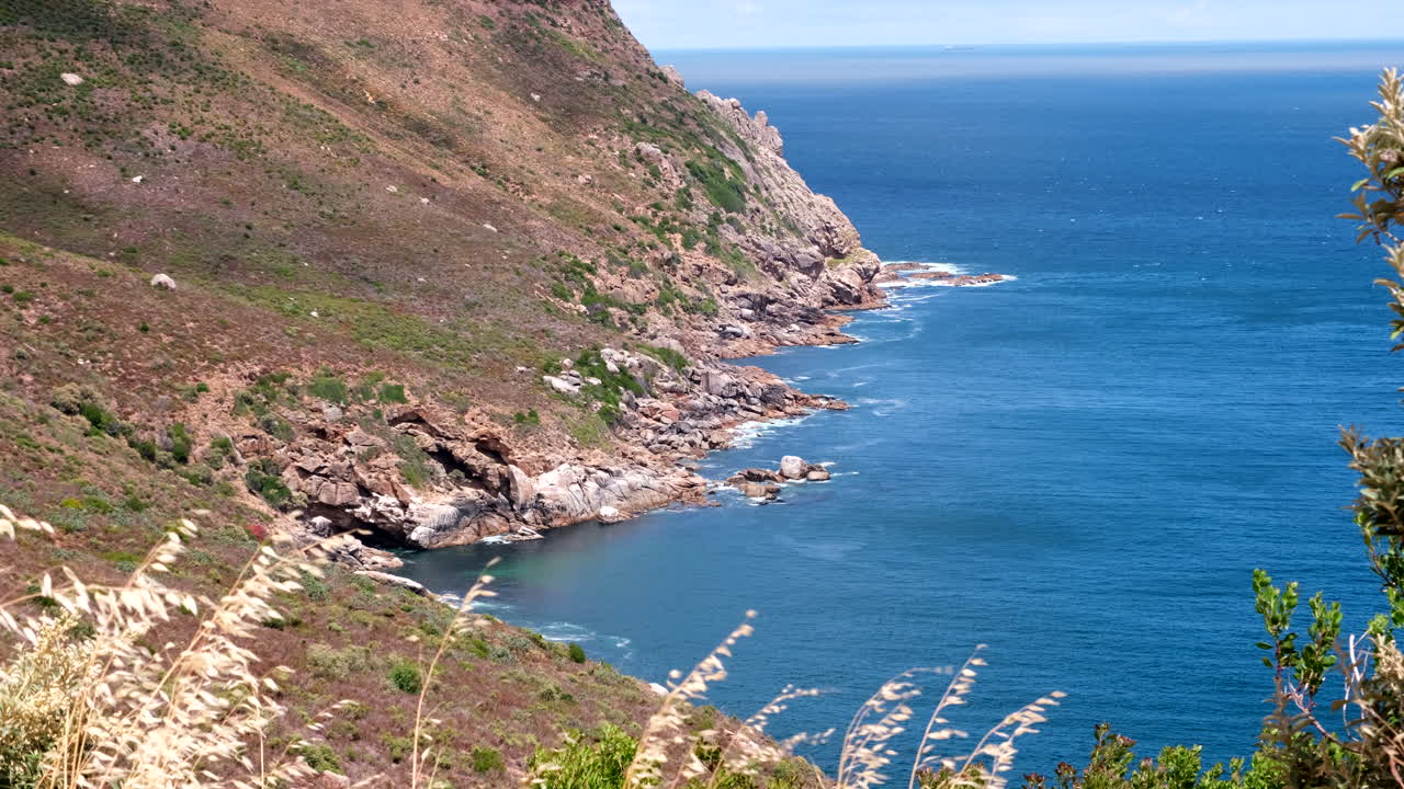 Steep slopes and rugged coastline of Chapman's Peak drive on Atlantic seaboard