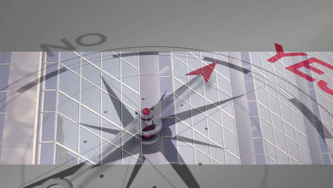compass needle pointing towards yes, reflecting on modern glass building facade