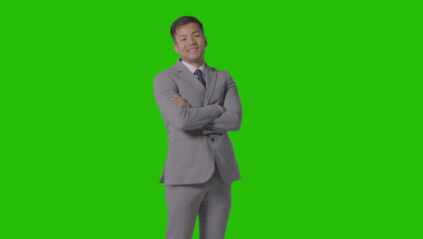 Three-Quarter-Length-Portrait-Of-Businessman-In-Suit-Against-Green-Screen-Smiling-At-Camera-2