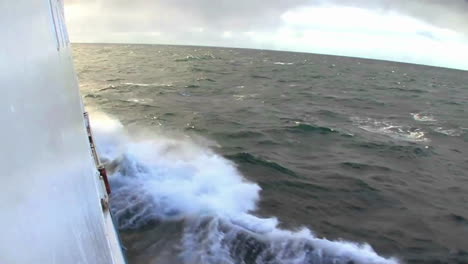 a ship plows through high seas