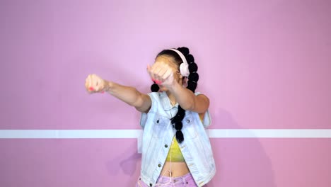 Stylish-ethnic-woman-in-headphones-listening-to-music-and-dancing