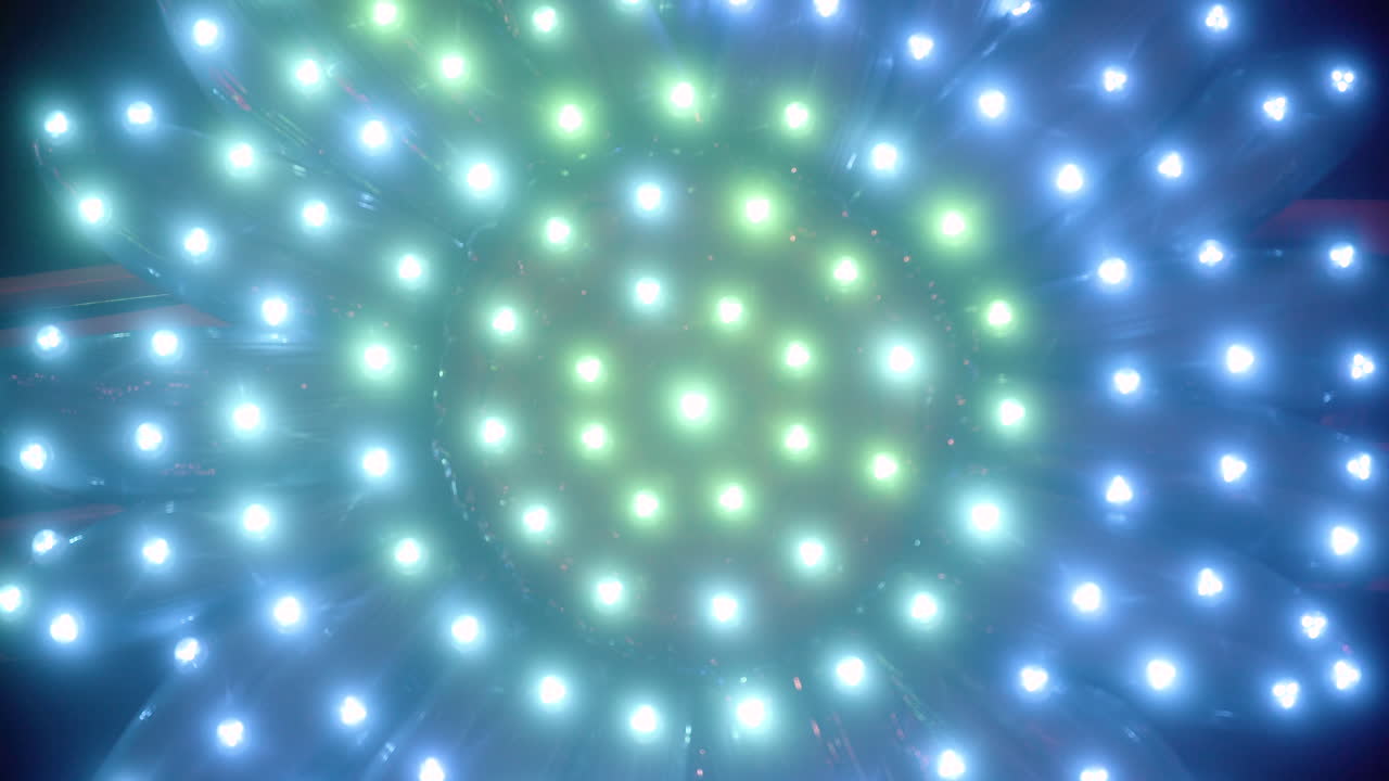 A carnival machine with glowing lights in the shaped like a spiral