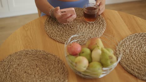 a pregnant woman enjoying her daily routine at home, relaxing in the living room and eating in the kitchen. the scene highlights comfort, maternity, and moments of self-care in a cozy setting